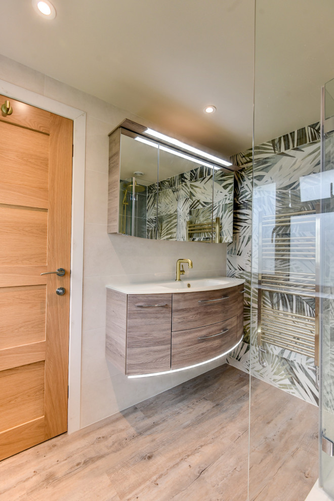 Inspiration for a medium sized world-inspired cloakroom in Sussex with flat-panel cabinets, medium wood cabinets, a one-piece toilet, green tiles, ceramic tiles, multi-coloured walls, medium hardwood flooring, a built-in sink, brown floors, white worktops, feature lighting and a floating vanity unit.