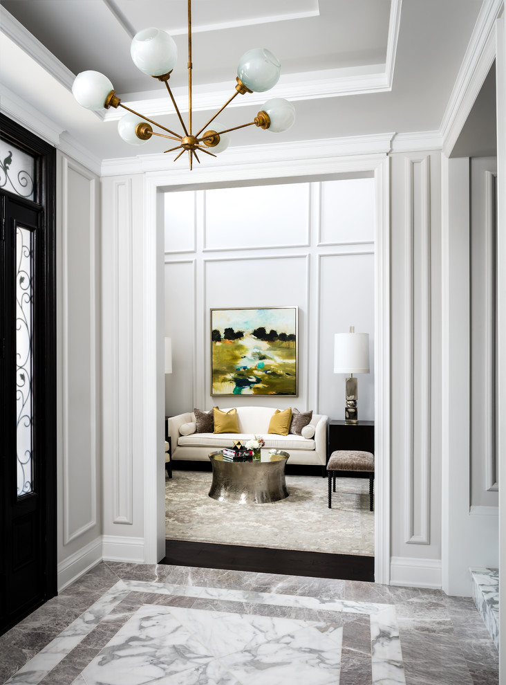 Design ideas for a mid-sized transitional hallway in Toronto with white walls and marble floors.