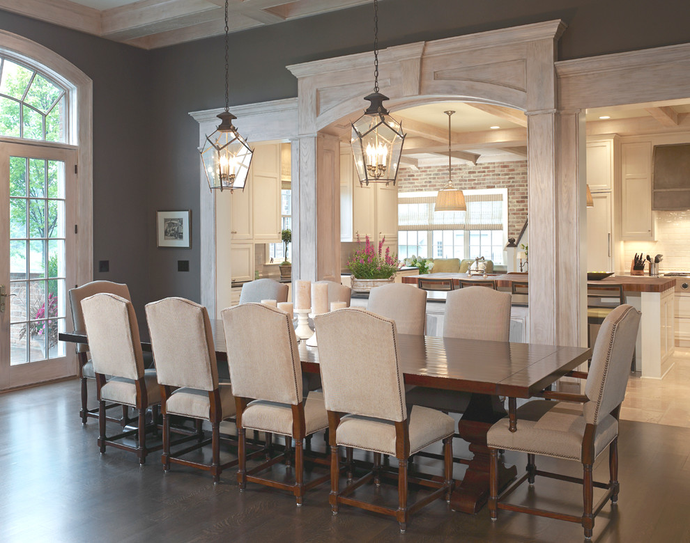 This is an example of a large traditional dining room in Columbus with grey walls and dark hardwood floors.