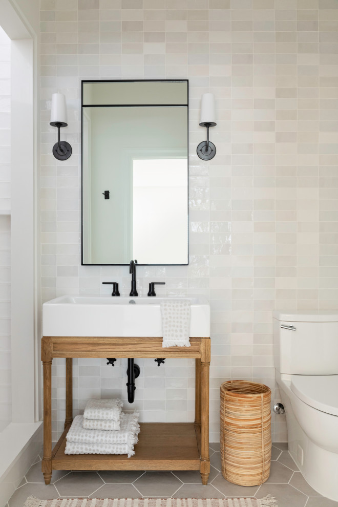 Inspiration for a mid-sized transitional bathroom in Orlando with open cabinets, brown cabinets, a corner shower, a one-piece toilet, white tile, ceramic tile, white walls, ceramic floors, grey floor, a hinged shower door, white benchtops, a single vanity and a freestanding vanity.