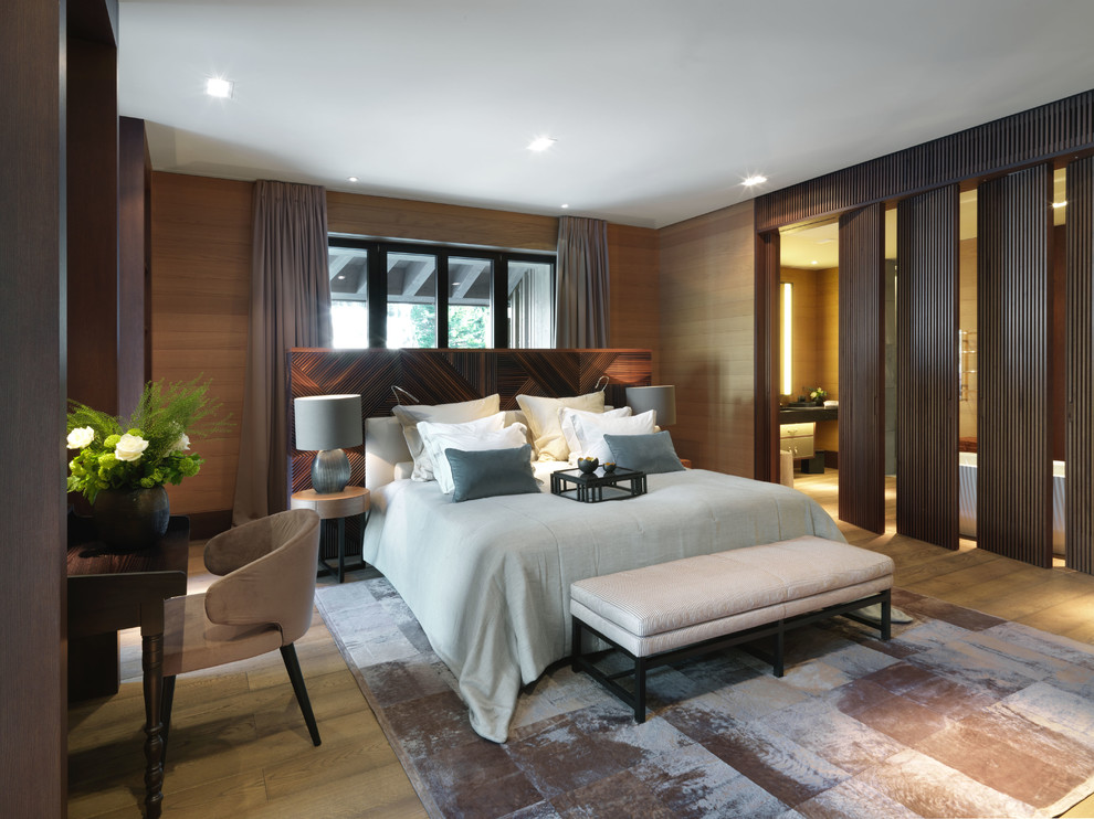 Contemporary master bedroom in Other with brown walls and carpet.