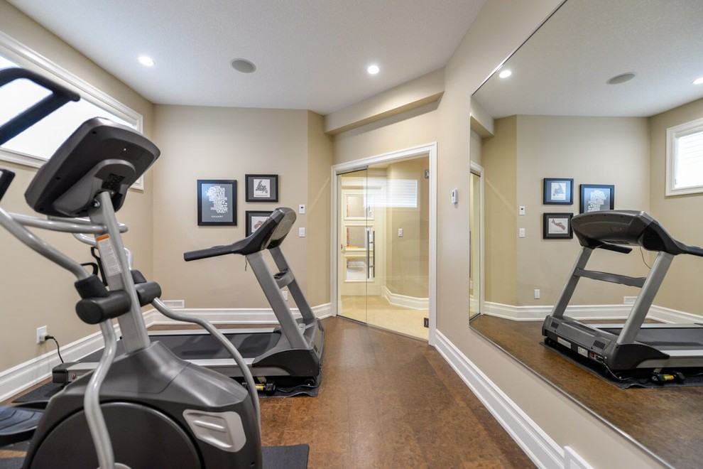 Photo of a small transitional multipurpose gym in Calgary with beige walls and cork floors.