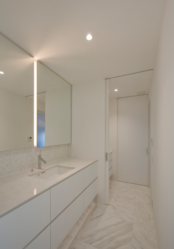 Medium sized modern cloakroom in Other with flat-panel cabinets, white cabinets, white tiles, marble tiles, white walls, marble flooring, a submerged sink, engineered stone worktops, white floors, white worktops, feature lighting and a built in vanity unit.