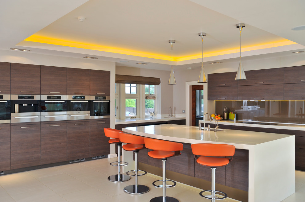 Inspiration for a large contemporary open plan kitchen in Manchester with an undermount sink, flat-panel cabinets, dark wood cabinets, brown splashback, stainless steel appliances and with island.