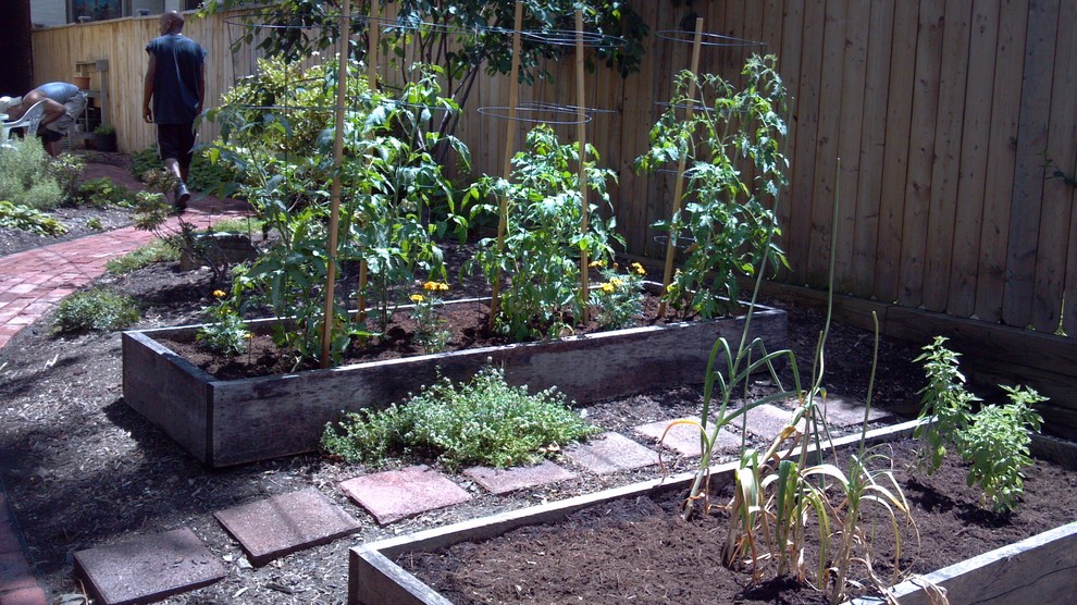 Mid-sized country backyard full sun formal garden in Other with a vegetable garden and brick pavers for spring.