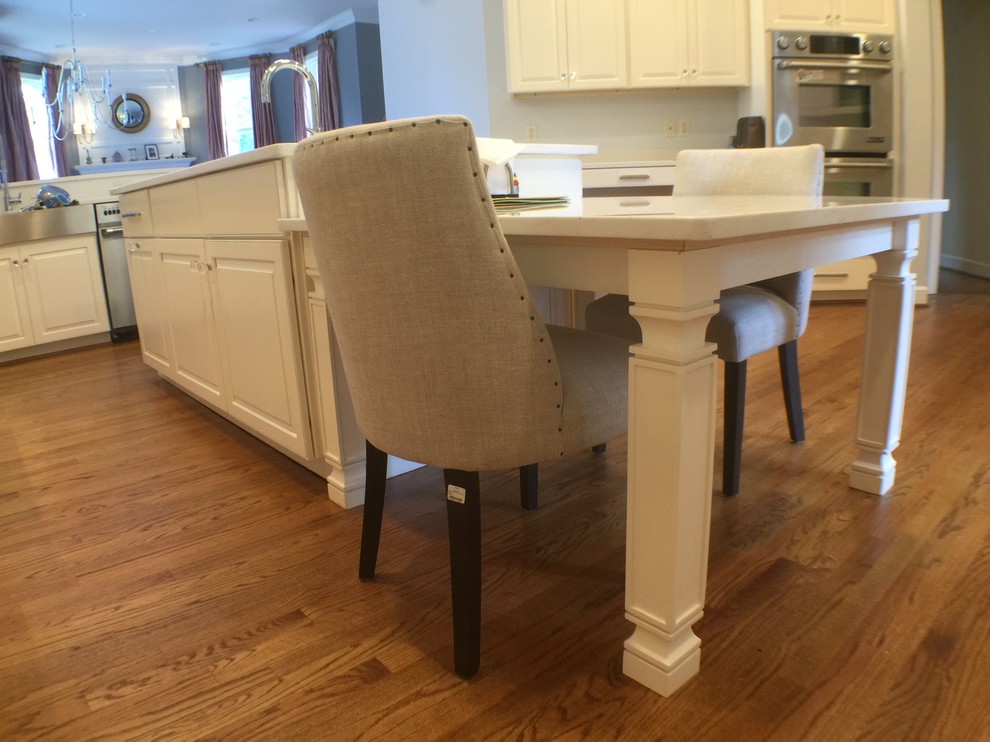 Open concept kitchen - large transitional u-shaped medium tone wood floor open concept kitchen idea in DC Metro with an undermount sink, raised-panel cabinets, white cabinets, quartzite countertops, stainless steel appliances and an island