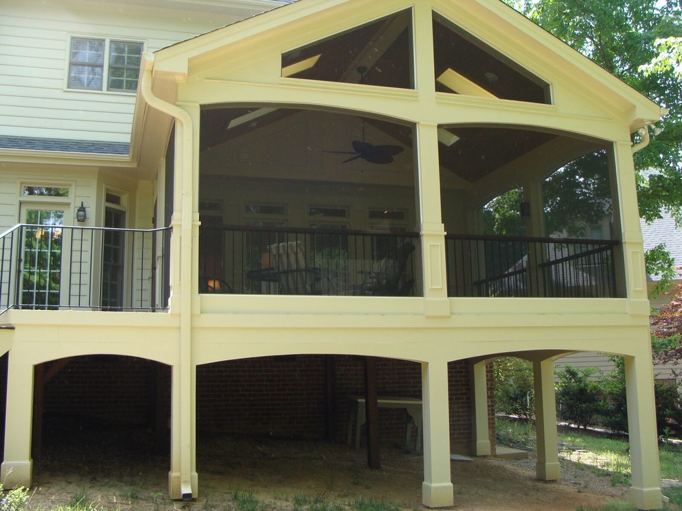 Photo of a large transitional backyard screened-in verandah in Raleigh with tile and a roof extension.