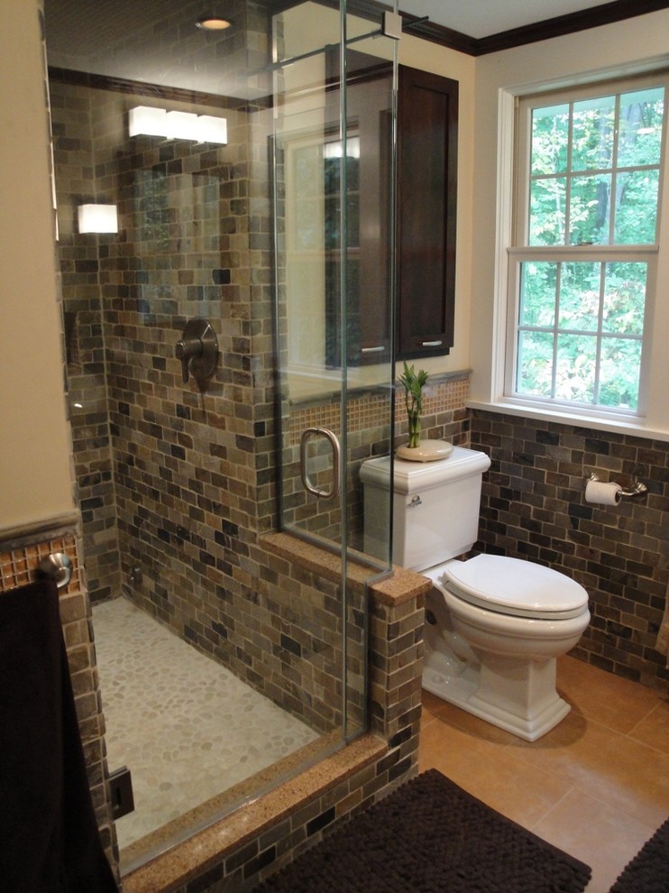 This is an example of a mid-sized contemporary master bathroom in Burlington with shaker cabinets, dark wood cabinets, an alcove shower, brown tile, stone tile, granite benchtops, a two-piece toilet, beige walls, porcelain floors and an undermount sink.