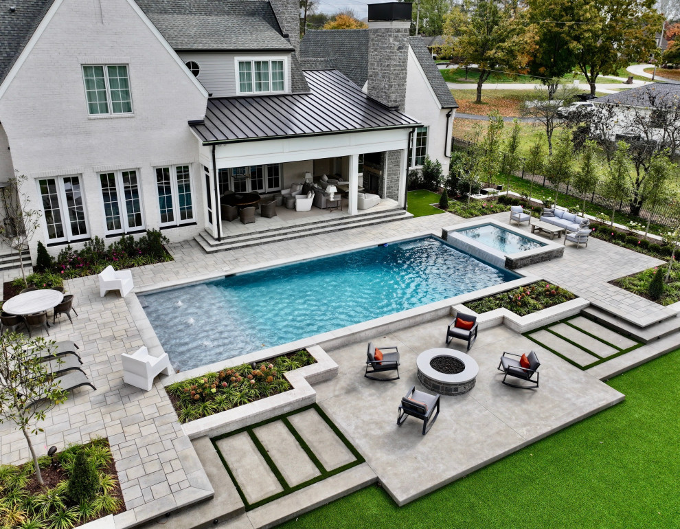 Example of a mid-sized transitional concrete paver and rectangular pool landscaping design in Nashville