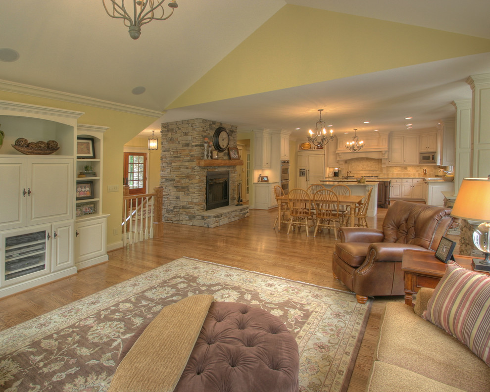 Design ideas for a traditional family room in Columbus with a stone fireplace surround.
