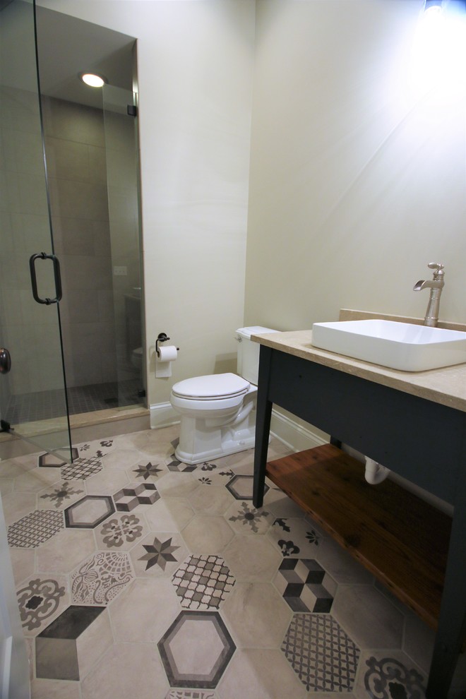 Photo of a large contemporary 3/4 bathroom in Chicago with black cabinets, an alcove shower, a two-piece toilet, gray tile, white walls, cement tiles, a vessel sink, granite benchtops, multi-coloured floor, a hinged shower door and beige benchtops.