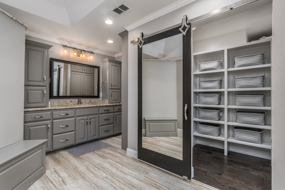 Photo of a large transitional master bathroom in Other with raised-panel cabinets, grey cabinets, a corner shower, a two-piece toilet, porcelain tile, beige walls, porcelain floors, an undermount sink, granite benchtops, an open shower, a shower seat, a double vanity and a built-in vanity.