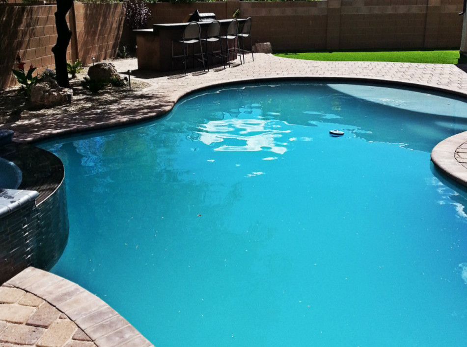 Inspiration for a large transitional backyard brick and custom-shaped hot tub remodel in Phoenix