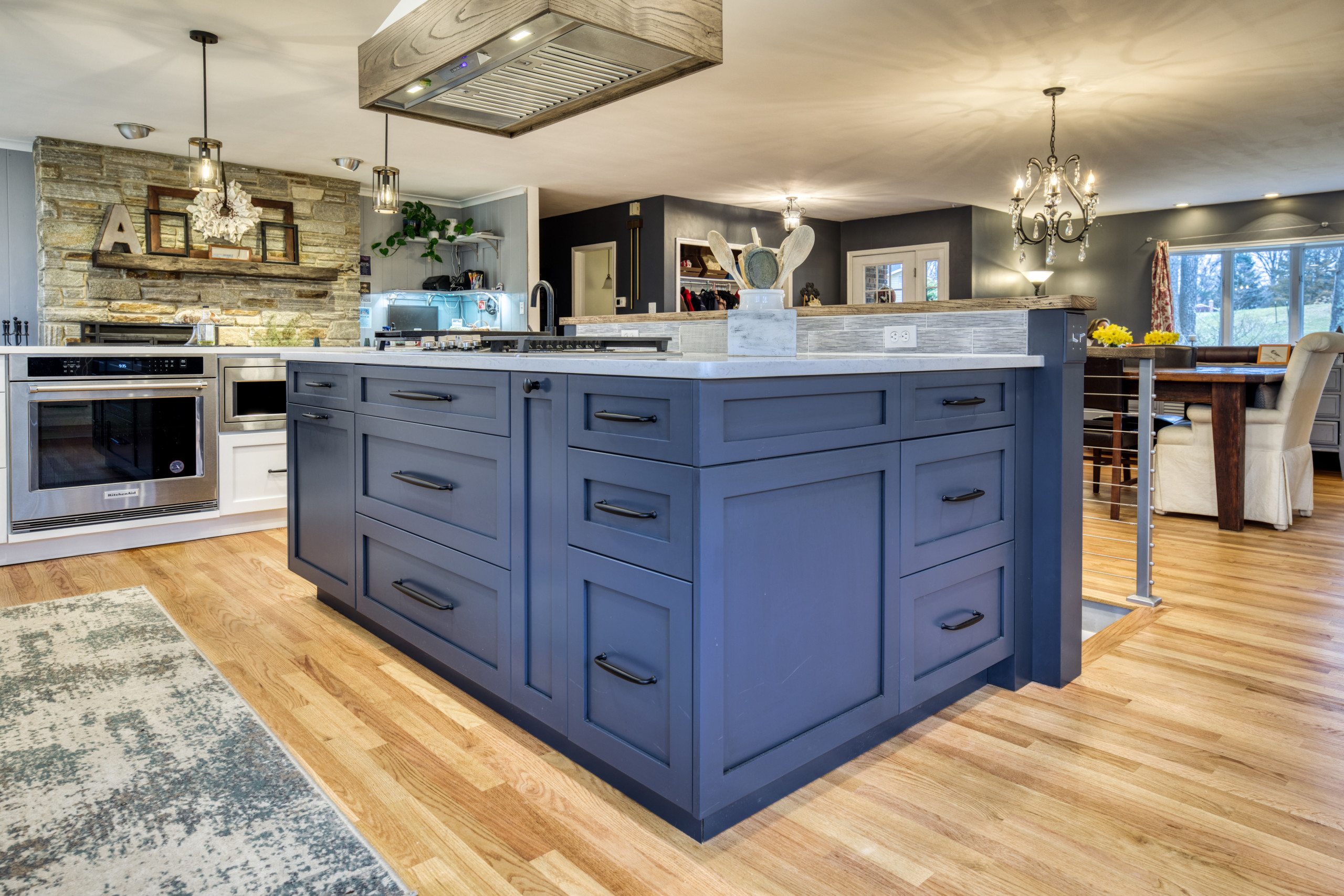 Inspiration for a large modern u-shaped light wood floor and brown floor open concept kitchen remodel in Baltimore with a farmhouse sink, shaker cabinets, blue cabinets, quartz countertops, multicolor