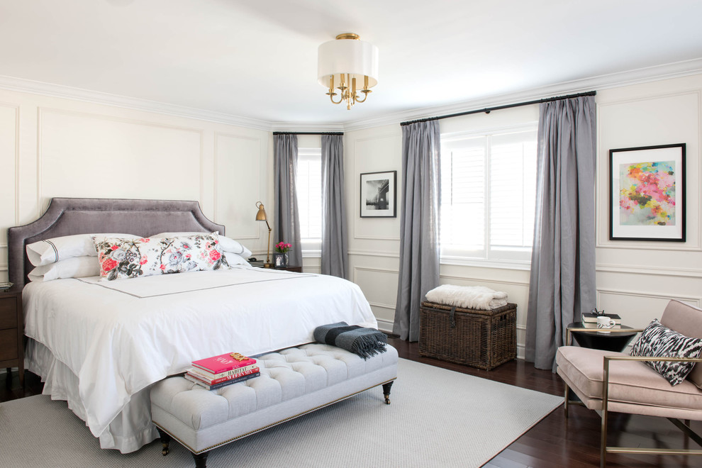Traditional master bedroom in Toronto with white walls and dark hardwood floors.