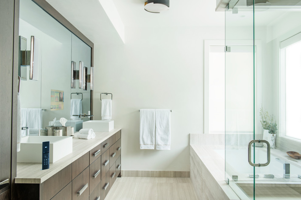 Mid-sized contemporary master bathroom in Other with medium wood cabinets, a corner tub, a corner shower, ceramic floors, granite benchtops, beige floor, white walls, a vessel sink and a hinged shower door.