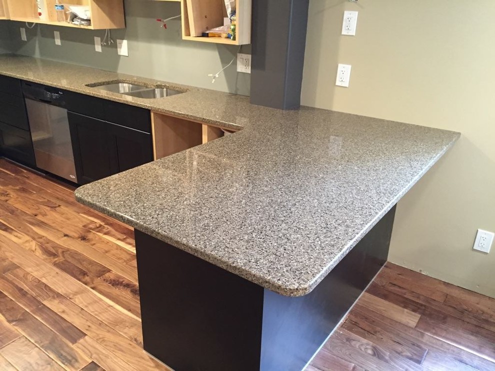 Eat-in kitchen - large transitional l-shaped light wood floor eat-in kitchen idea with an undermount sink, shaker cabinets, dark wood cabinets, quartz countertops, stainless steel appliances and an island