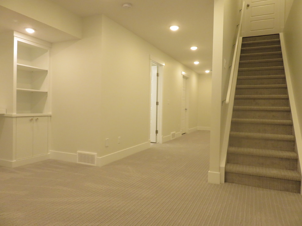 Inspiration for a mid-sized transitional look-out carpeted and gray floor basement remodel in Calgary with white walls
