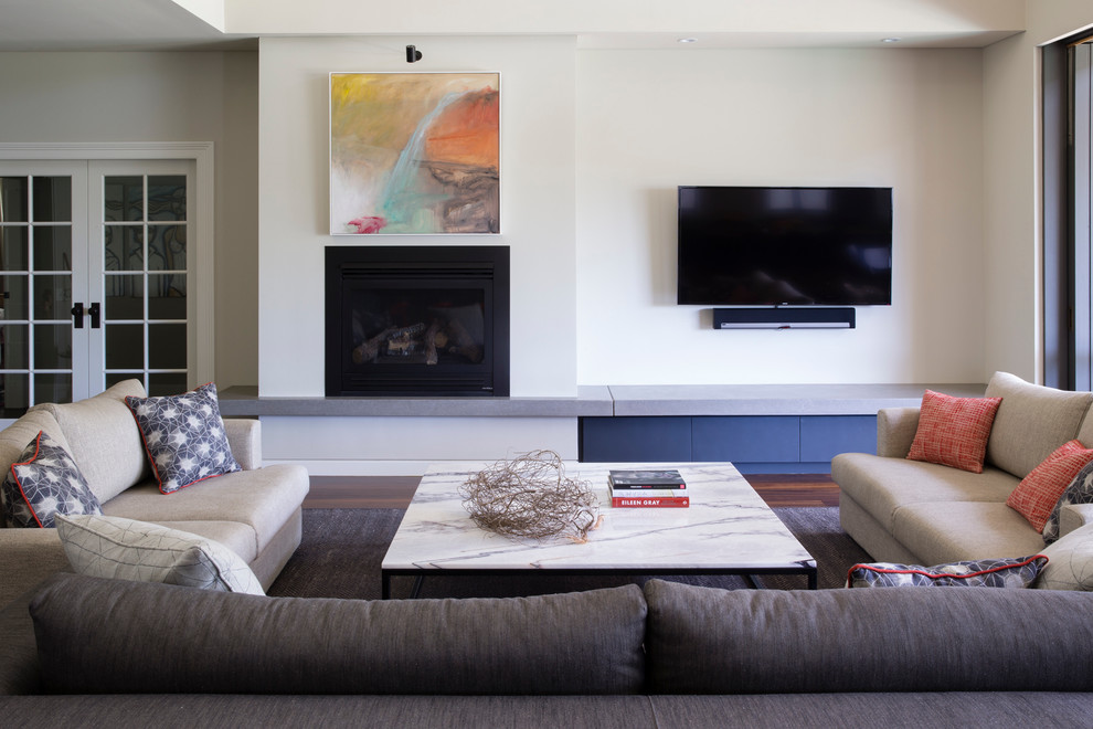 This is an example of a contemporary living room in Sydney with dark hardwood floors, a plaster fireplace surround and a wall-mounted tv.