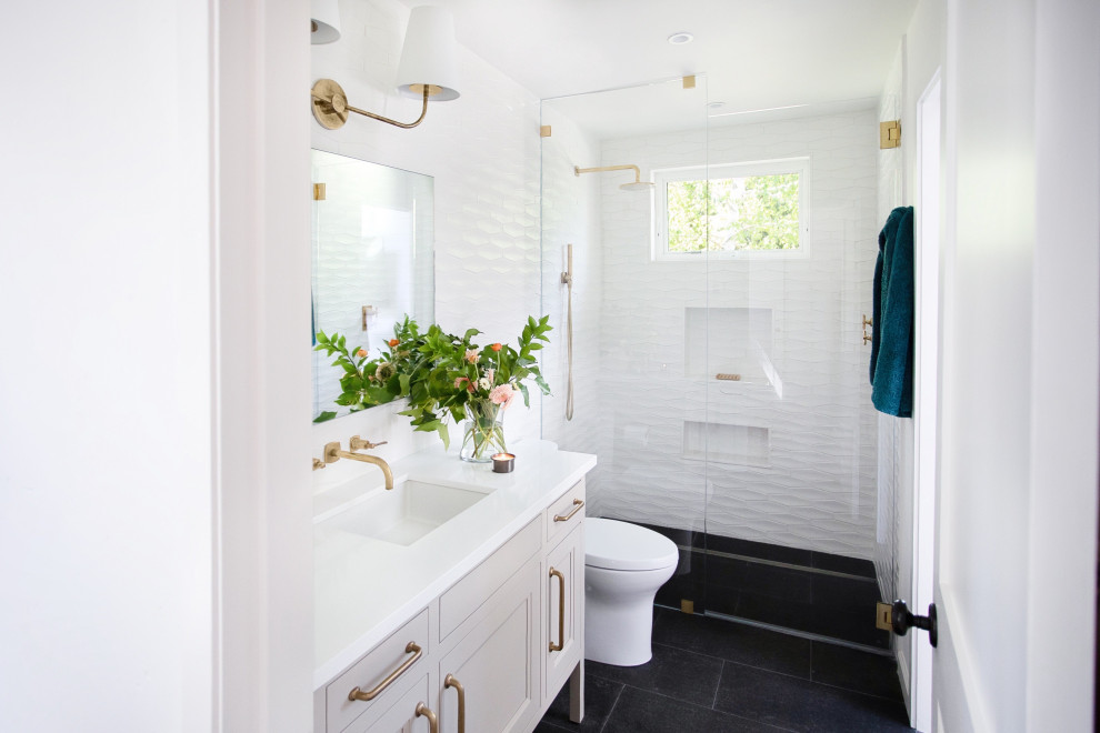 Photo of a medium sized classic bathroom in San Francisco with a freestanding bath, white tiles, white walls, black floors, a hinged door, a single sink, a built in vanity unit, a one-piece toilet, ceramic tiles, white worktops and recessed-panel cabinets.
