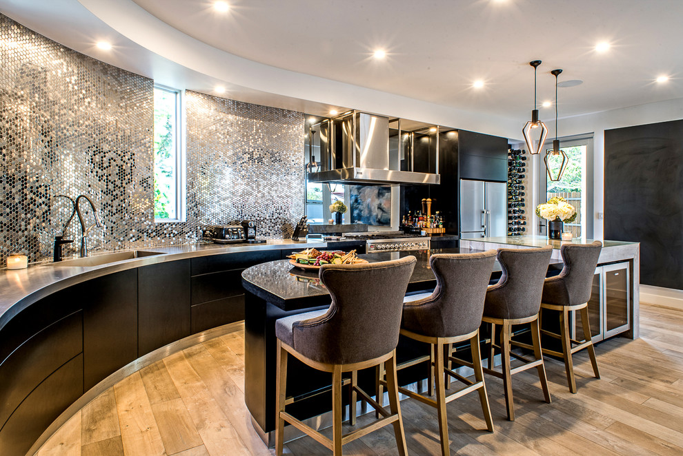 This is an example of a contemporary kitchen in Adelaide with flat-panel cabinets, black cabinets, stainless steel benchtops, stainless steel appliances, with island, an integrated sink, metallic splashback, metal splashback, light hardwood floors and beige floor.