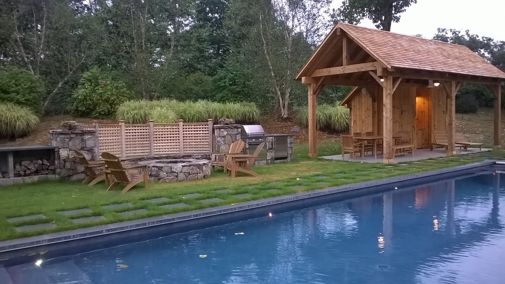 Inspiration for a mid-sized country backyard rectangular pool in Bridgeport with a pool house and natural stone pavers.
