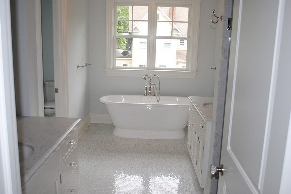Example of a large transitional master white floor freestanding bathtub design with flat-panel cabinets, white cabinets, blue walls and an undermount sink