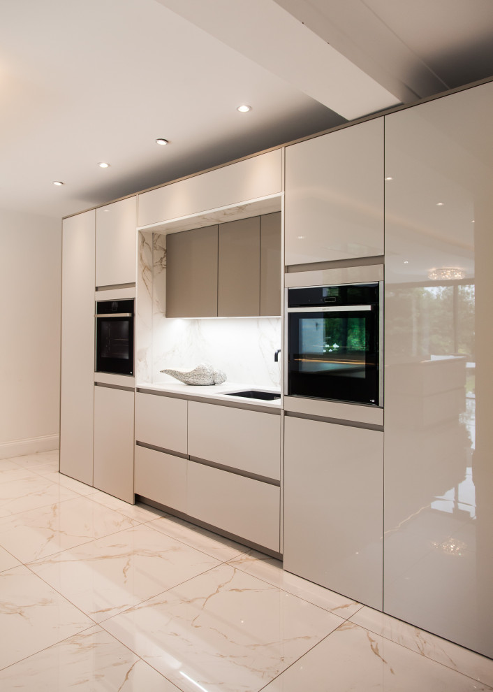 Large galley eat-in kitchen in Essex with a drop-in sink, flat-panel cabinets, solid surface benchtops, white splashback, porcelain floors, with island, multi-coloured floor, yellow benchtop and recessed.