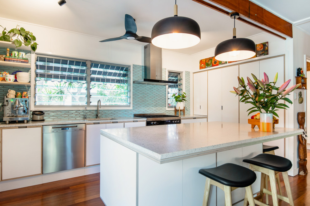 Design ideas for a mid-sized midcentury u-shaped kitchen in Sunshine Coast with an integrated sink, flat-panel cabinets, white cabinets, laminate benchtops, blue splashback, mosaic tile splashback, black appliances, with island and multi-coloured benchtop.