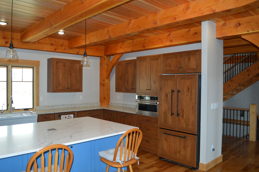 Eat-in kitchen - mid-sized rustic u-shaped medium tone wood floor, brown floor and exposed beam eat-in kitchen idea with a farmhouse sink, shaker cabinets, medium tone wood cabinets, paneled appliances and an island