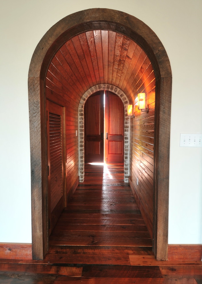 Inspiration for a mediterranean hallway in Charleston with dark hardwood floors.