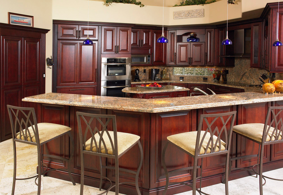 Inspiration for a mid-sized traditional u-shaped kitchen in Miami with an undermount sink, raised-panel cabinets, medium wood cabinets, granite benchtops, multi-coloured splashback, stone slab splashback, stainless steel appliances, ceramic floors, with island and beige floor.
