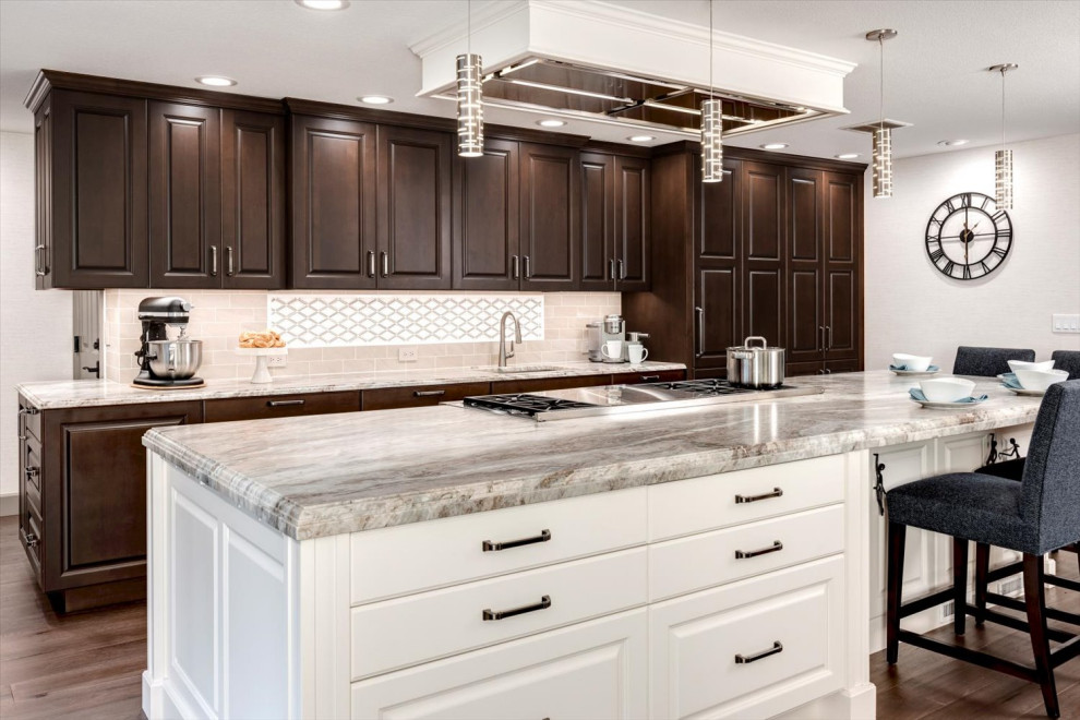 Inspiration for a huge transitional l-shaped medium tone wood floor and brown floor open concept kitchen remodel in Seattle with a single-bowl sink, raised-panel cabinets, brown cabinets, quartzite countertops, beige backsplash, porcelain backsplash, stainless steel appliances, an island and multicolored countertops