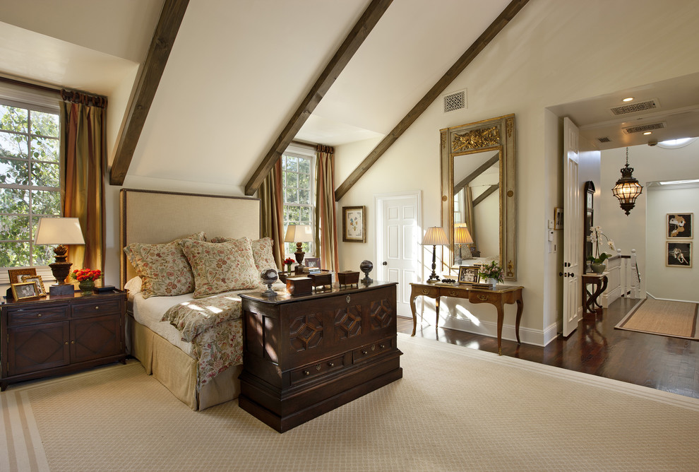 Photo of a traditional bedroom in Los Angeles with beige walls and dark hardwood floors.