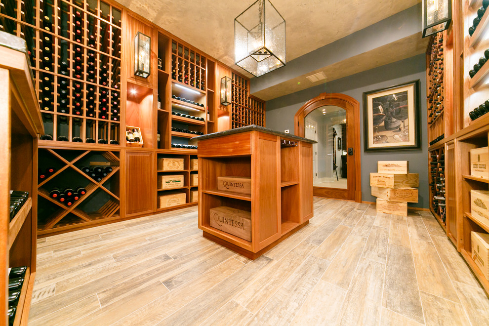 Photo of a large traditional wine cellar in New York with porcelain floors and display racks.