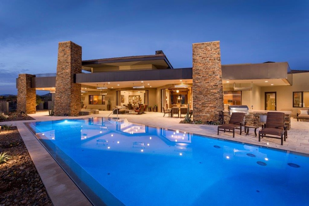 Example of a large backyard tile and rectangular lap pool design in Phoenix