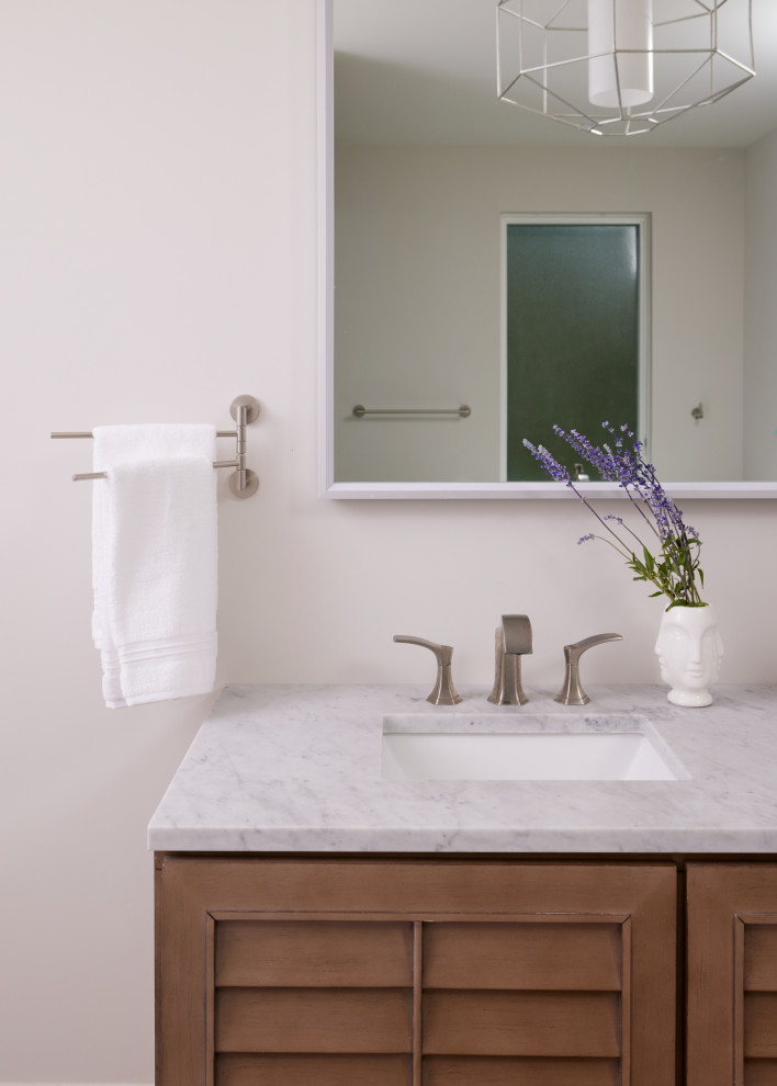 Design ideas for a large modern master bathroom in Richmond with louvered cabinets, brown cabinets, beige walls, an undermount sink, marble benchtops, white benchtops, a double vanity and a built-in vanity.