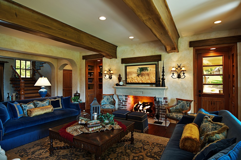 Photo of a mediterranean living room in Chicago with a brick fireplace surround.
