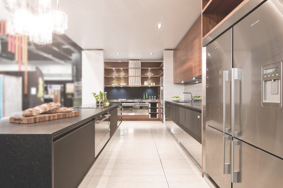 Photo of a mid-sized contemporary galley eat-in kitchen in Vancouver with an undermount sink, flat-panel cabinets, black cabinets, solid surface benchtops, stainless steel appliances, ceramic floors and with island.