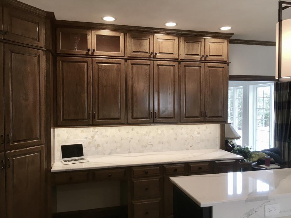 Inspiration for a large transitional u-shaped medium tone wood floor open concept kitchen remodel with an undermount sink, raised-panel cabinets, medium tone wood cabinets, quartz countertops, multicolored backsplash, mosaic tile backsplash, stainless steel appliances and an island
