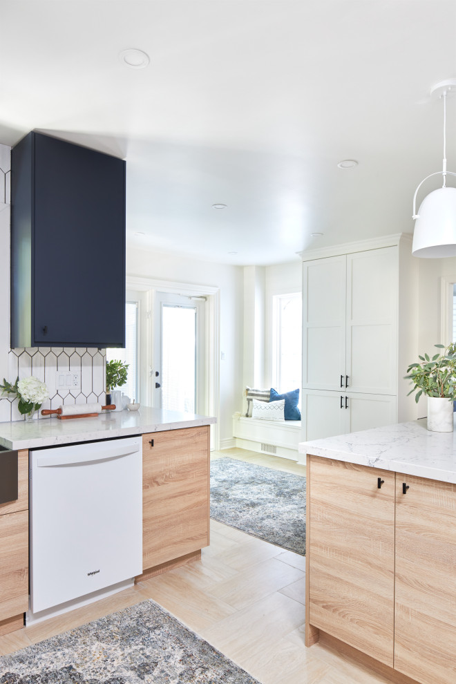 This is an example of a mid-sized modern separate kitchen in Toronto with a farmhouse sink, flat-panel cabinets, blue cabinets, quartz benchtops, white splashback, porcelain splashback, white appliances, porcelain floors, with island, beige floor and white benchtop.