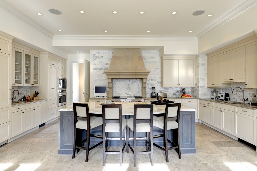 Photo of a transitional u-shaped kitchen in Atlanta with an undermount sink, shaker cabinets, beige cabinets, multi-coloured splashback, stainless steel appliances and with island.