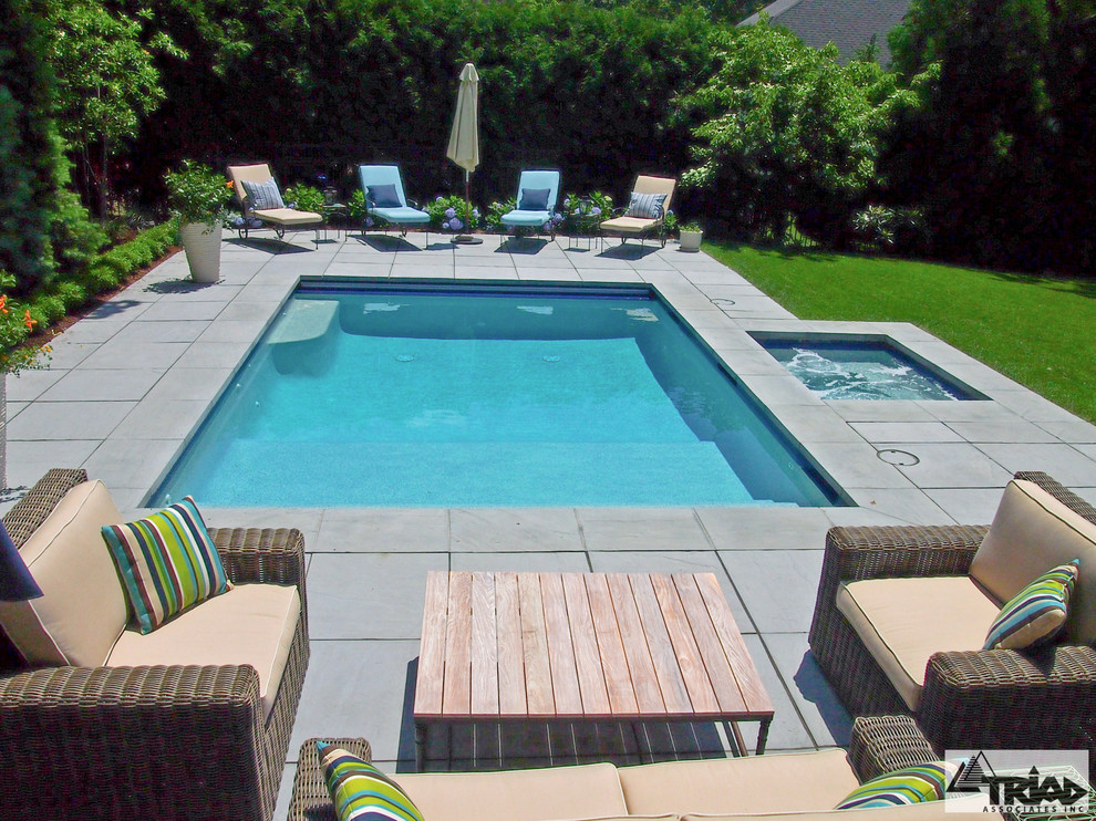 Inspiration for a small contemporary backyard rectangular pool in Boston with concrete pavers and a hot tub.