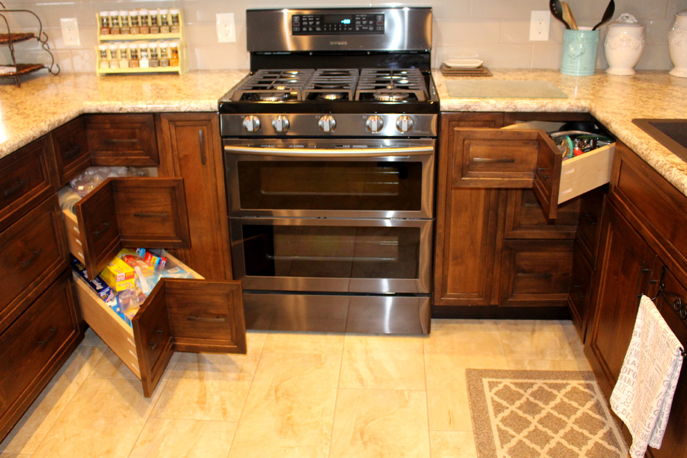 Inspiration for a transitional u-shaped porcelain tile eat-in kitchen remodel with flat-panel cabinets, medium tone wood cabinets, laminate countertops, beige backsplash and stainless steel appliances