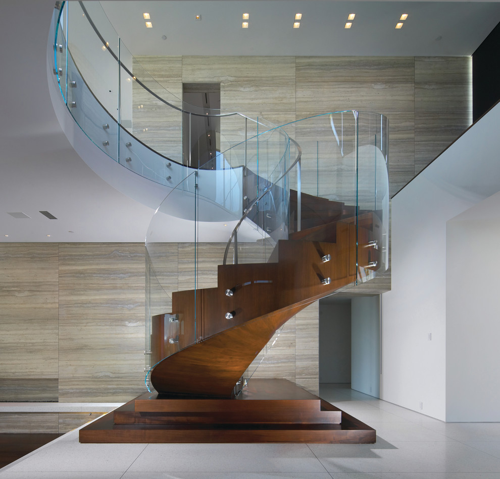 Large contemporary wood curved staircase in Orange County with wood risers.