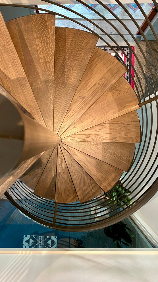 Inspiration for an industrial wood spiral metal railing staircase in Minneapolis.