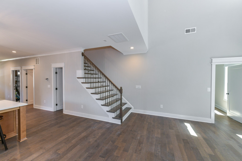 Design ideas for a mid-sized arts and crafts wood straight staircase in Charlotte with painted wood risers and wood railing.