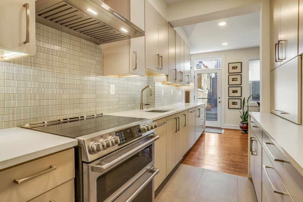 Mid-sized transitional galley kitchen pantry photo in DC Metro with a drop-in sink, flat-panel cabinets, light wood cabinets, stainless steel appliances and no island