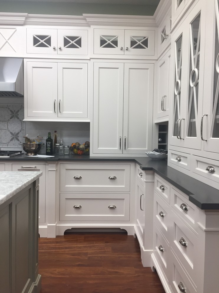 Inspiration for a transitional kitchen remodel in Boston with shaker cabinets, quartz countertops, an island, white cabinets, white backsplash and subway tile backsplash