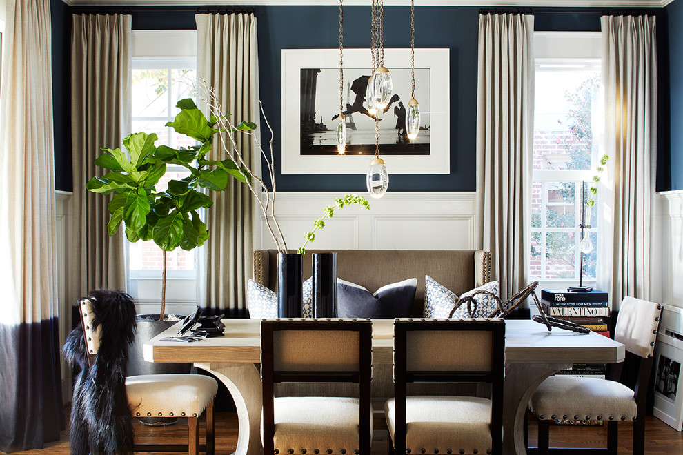 Photo of a transitional dining room in Atlanta with blue walls, medium hardwood floors and brown floor.